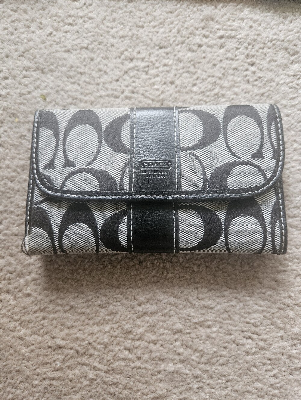 Vintage Coach black and gray signature jacquard canvas flap wallet.